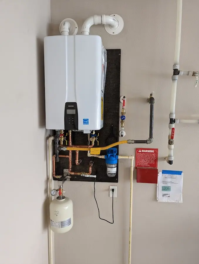 Professional plumber installing copper piping in a Hugoton home